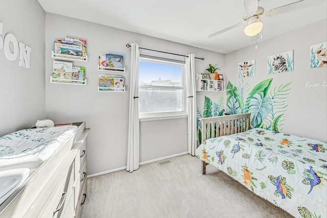 bedroom featuring light colored carpet and ceiling fan