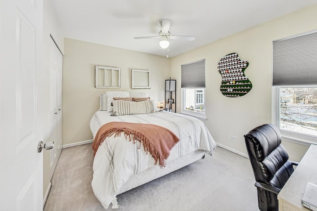 bedroom featuring light colored carpet and ceiling fan