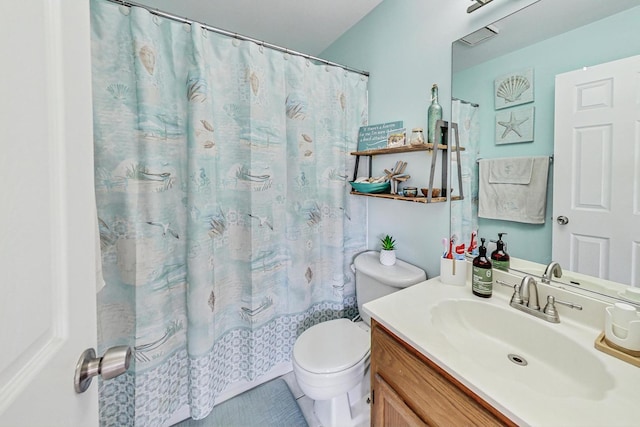 bathroom with vanity, walk in shower, and toilet