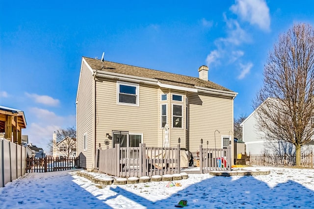 snow covered property with a wooden deck