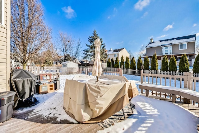 snow covered deck featuring area for grilling