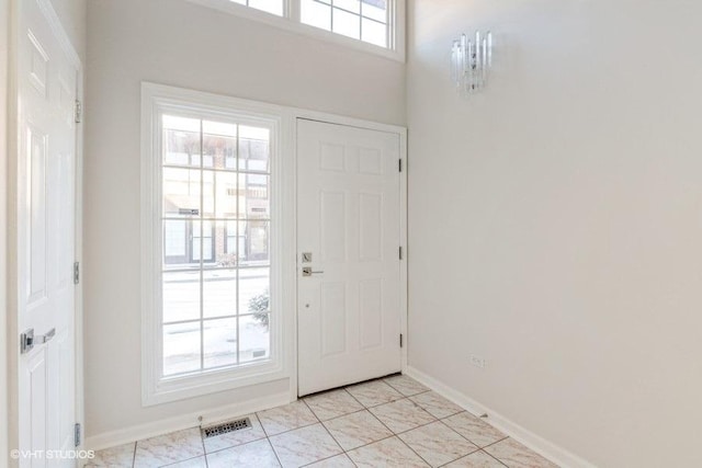 entryway with light tile patterned floors