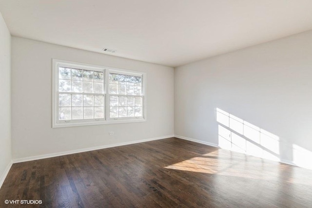 spare room with dark hardwood / wood-style floors