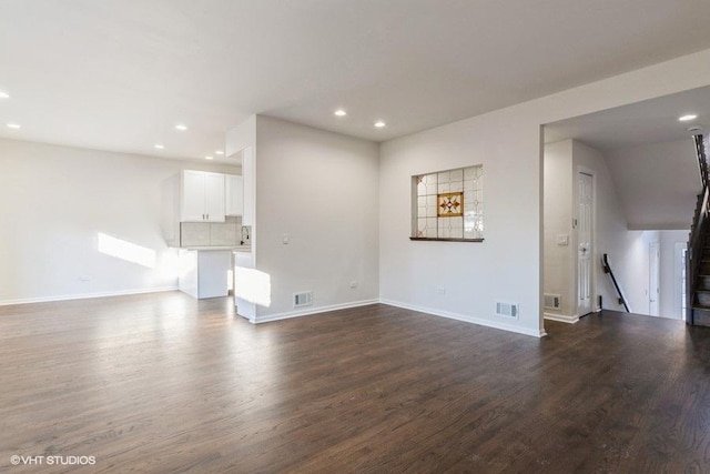 unfurnished living room featuring dark hardwood / wood-style floors