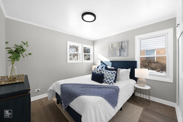 bedroom with ornamental molding and dark wood-type flooring