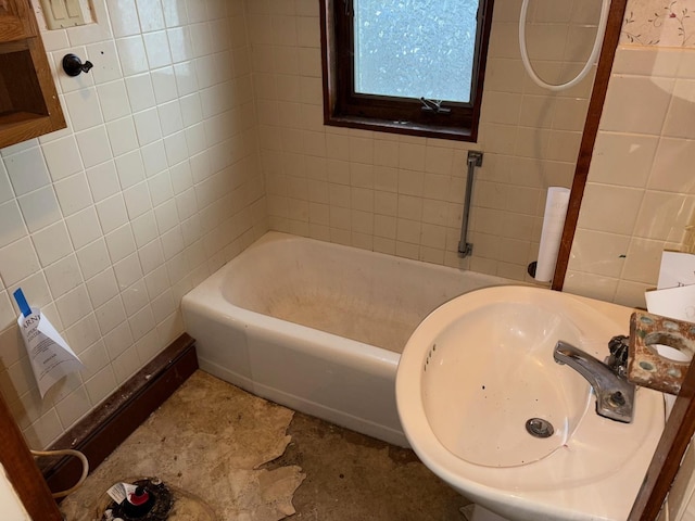 bathroom featuring tile walls and sink