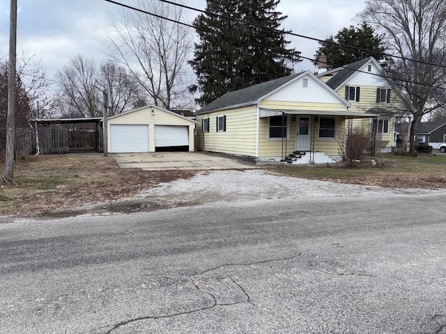 view of front of property featuring a garage and an outdoor structure