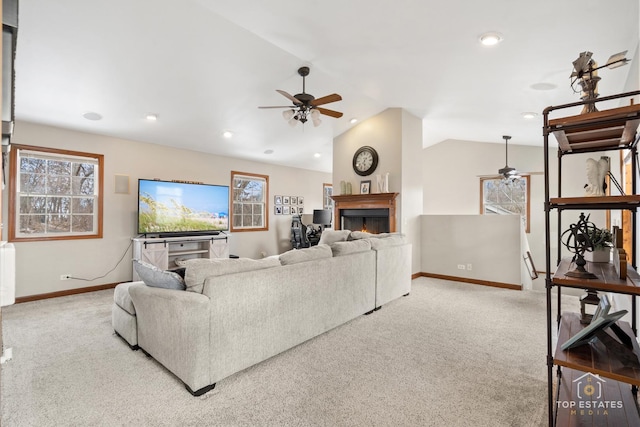 carpeted living room with vaulted ceiling and ceiling fan