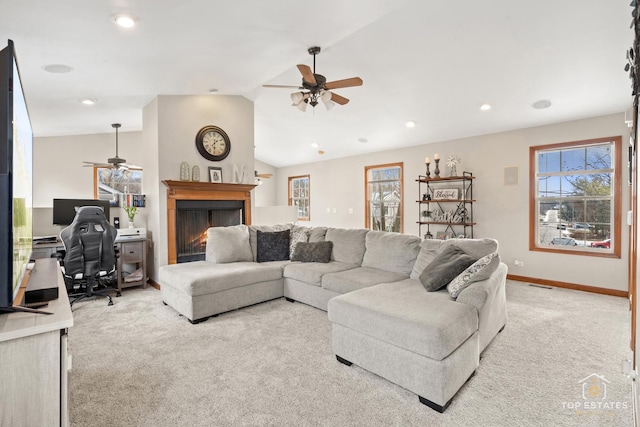 carpeted living room featuring ceiling fan and vaulted ceiling