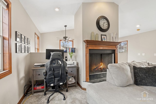 carpeted office space featuring lofted ceiling and ceiling fan