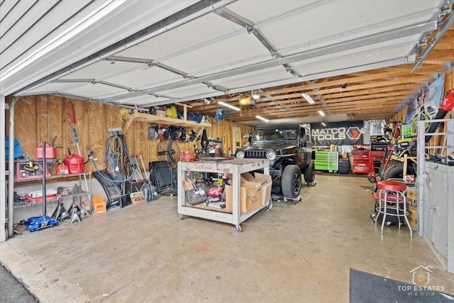 garage featuring a garage door opener and a workshop area