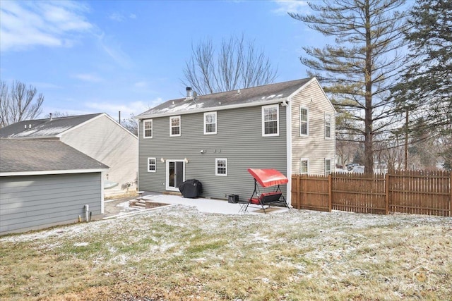 rear view of house featuring a patio and a lawn