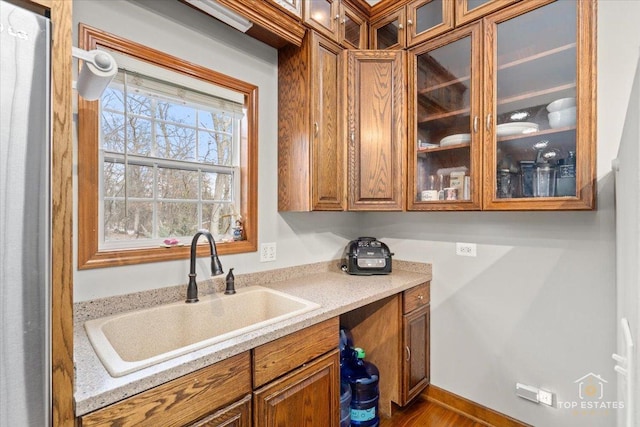 kitchen featuring light stone countertops and sink