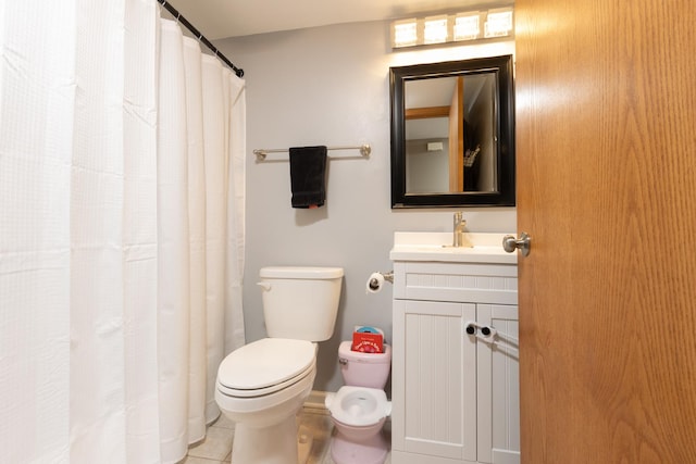 bathroom with toilet, tile patterned flooring, and vanity