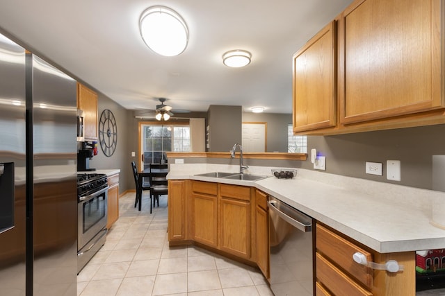 kitchen with sink, stainless steel appliances, a healthy amount of sunlight, and kitchen peninsula