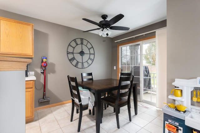 tiled dining area with ceiling fan