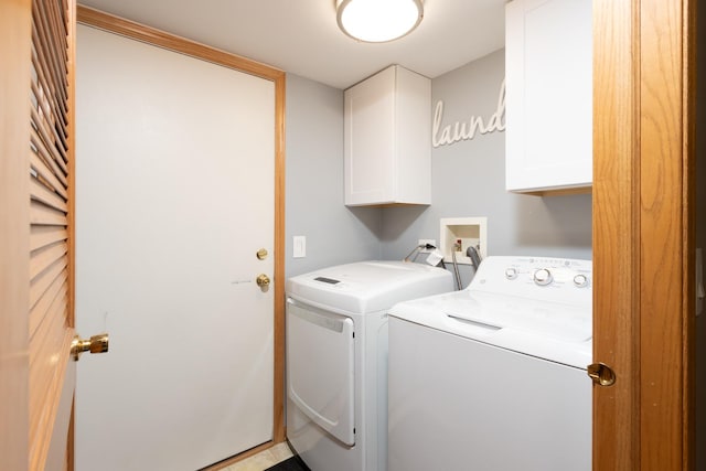 laundry area with washer and dryer and cabinets