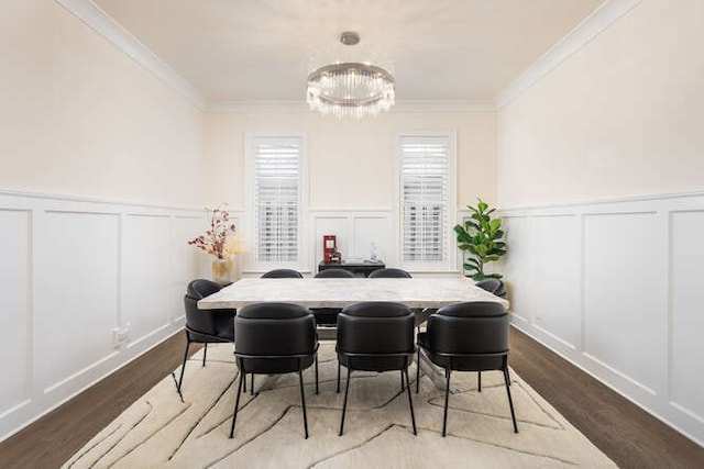 dining area featuring crown molding, wood-type flooring, and a chandelier