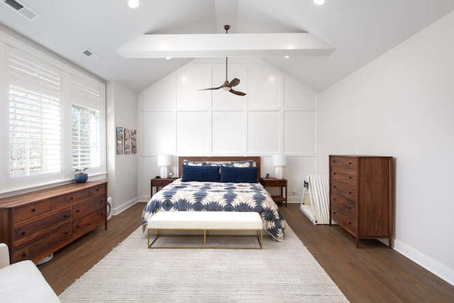 bedroom with dark wood-type flooring and vaulted ceiling with beams