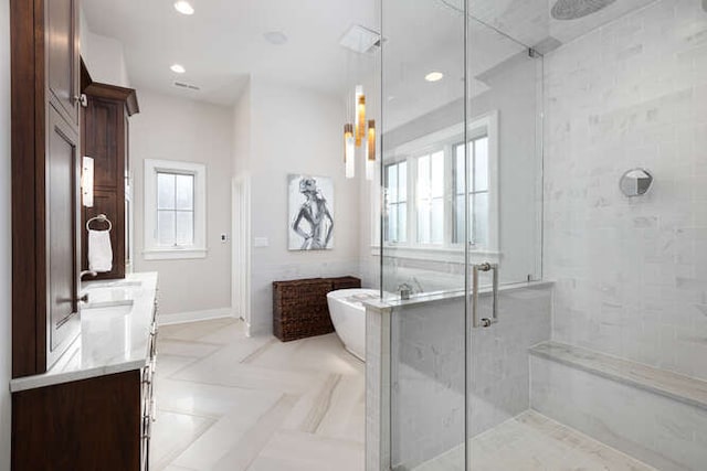 bathroom featuring vanity and independent shower and bath