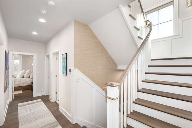 stairs featuring hardwood / wood-style flooring and a healthy amount of sunlight