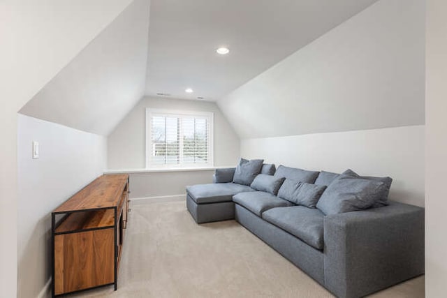 carpeted living room featuring lofted ceiling