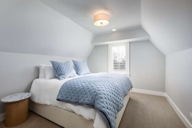 carpeted bedroom featuring vaulted ceiling