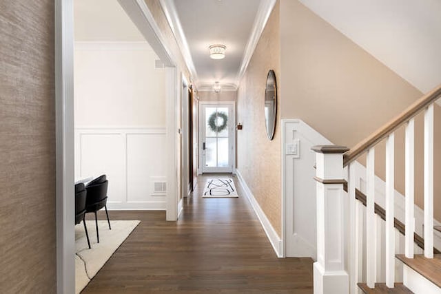 hall featuring crown molding and dark hardwood / wood-style floors