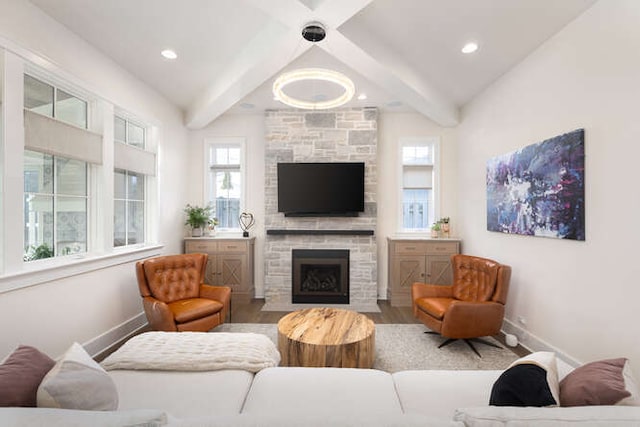 living room with hardwood / wood-style flooring, a fireplace, and beam ceiling