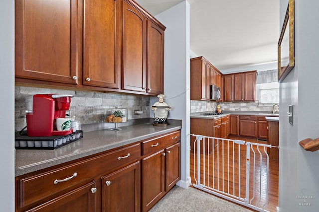 kitchen with appliances with stainless steel finishes, decorative backsplash, and sink