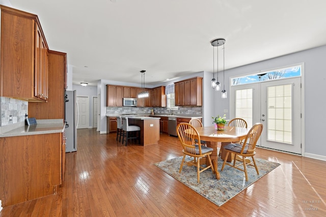 dining room featuring hardwood / wood-style flooring and french doors