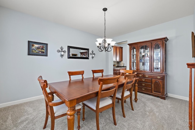 dining space with light carpet and a notable chandelier