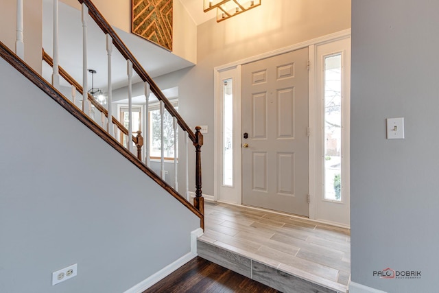 entrance foyer with plenty of natural light and hardwood / wood-style flooring