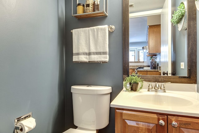 bathroom featuring toilet and vanity