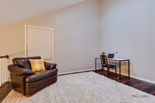 sitting room with dark hardwood / wood-style flooring and vaulted ceiling