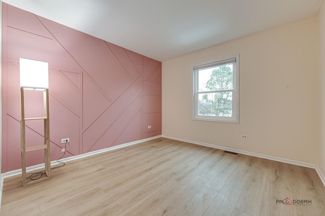 empty room with light hardwood / wood-style floors