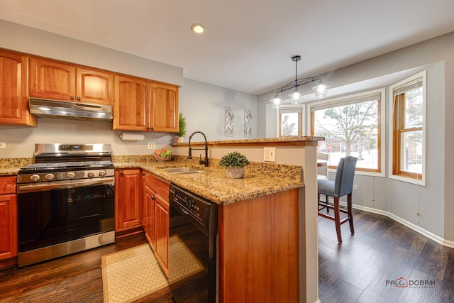 kitchen featuring dishwasher, dark hardwood / wood-style flooring, sink, hanging light fixtures, and stainless steel range with gas cooktop