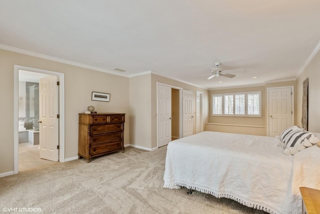 bedroom featuring ensuite bath, light colored carpet, ornamental molding, two closets, and ceiling fan