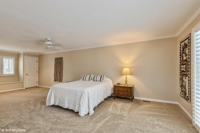 bedroom with crown molding, ceiling fan, and carpet