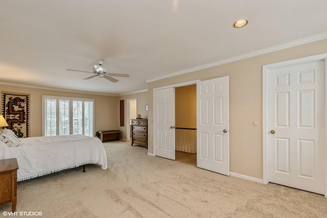 carpeted bedroom featuring crown molding and ceiling fan