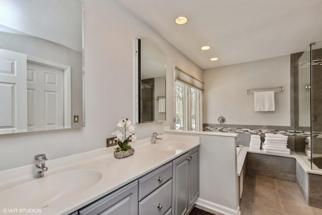 bathroom featuring vanity, tile patterned floors, and shower with separate bathtub