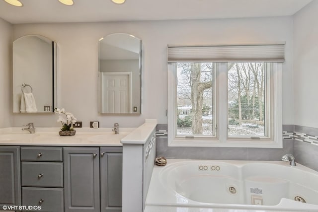 bathroom with a tub to relax in and vanity