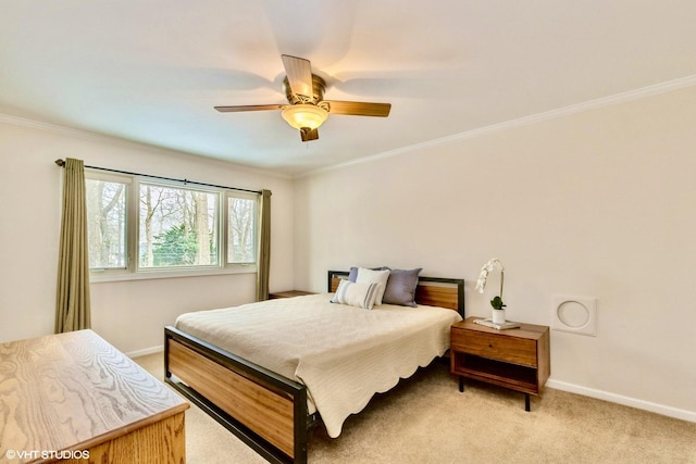 carpeted bedroom with ornamental molding and ceiling fan