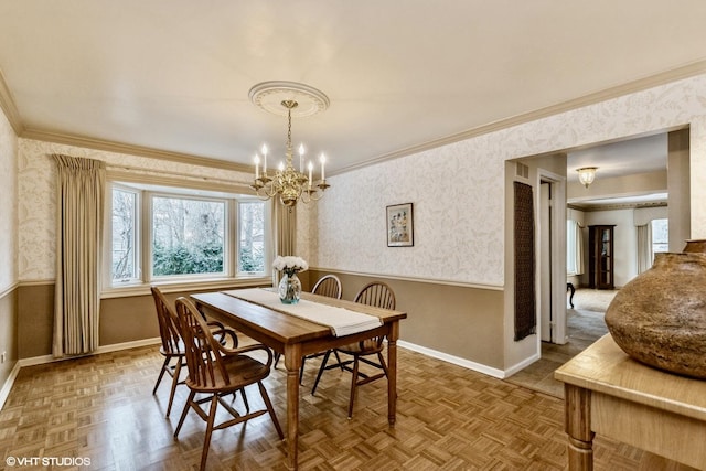 dining space featuring crown molding, parquet flooring, and a notable chandelier