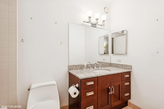 bathroom featuring toilet and vanity