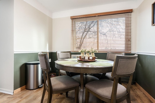 dining space with light hardwood / wood-style floors