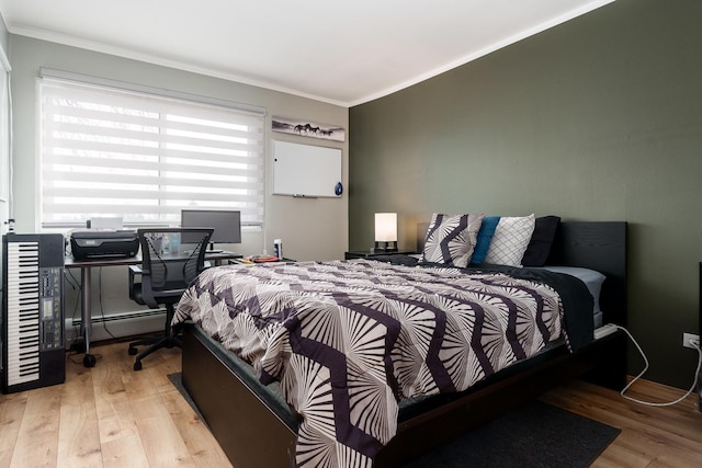 bedroom with light wood-type flooring, baseboard heating, and ornamental molding