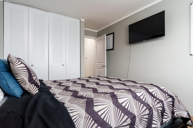 bedroom with a closet and ornamental molding