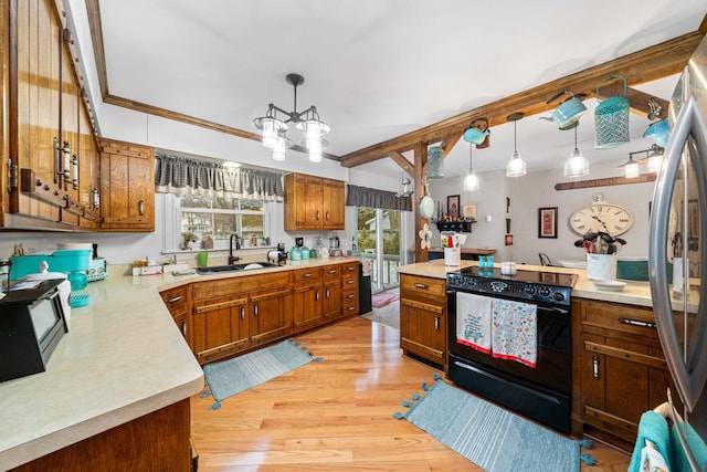 kitchen featuring decorative light fixtures, light hardwood / wood-style floors, sink, crown molding, and black range with electric cooktop