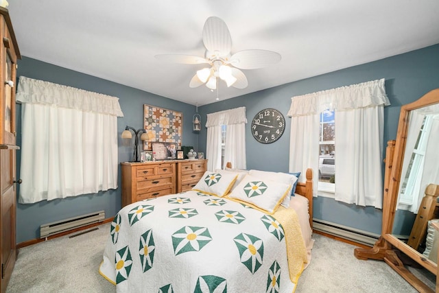 carpeted bedroom featuring ceiling fan and baseboard heating